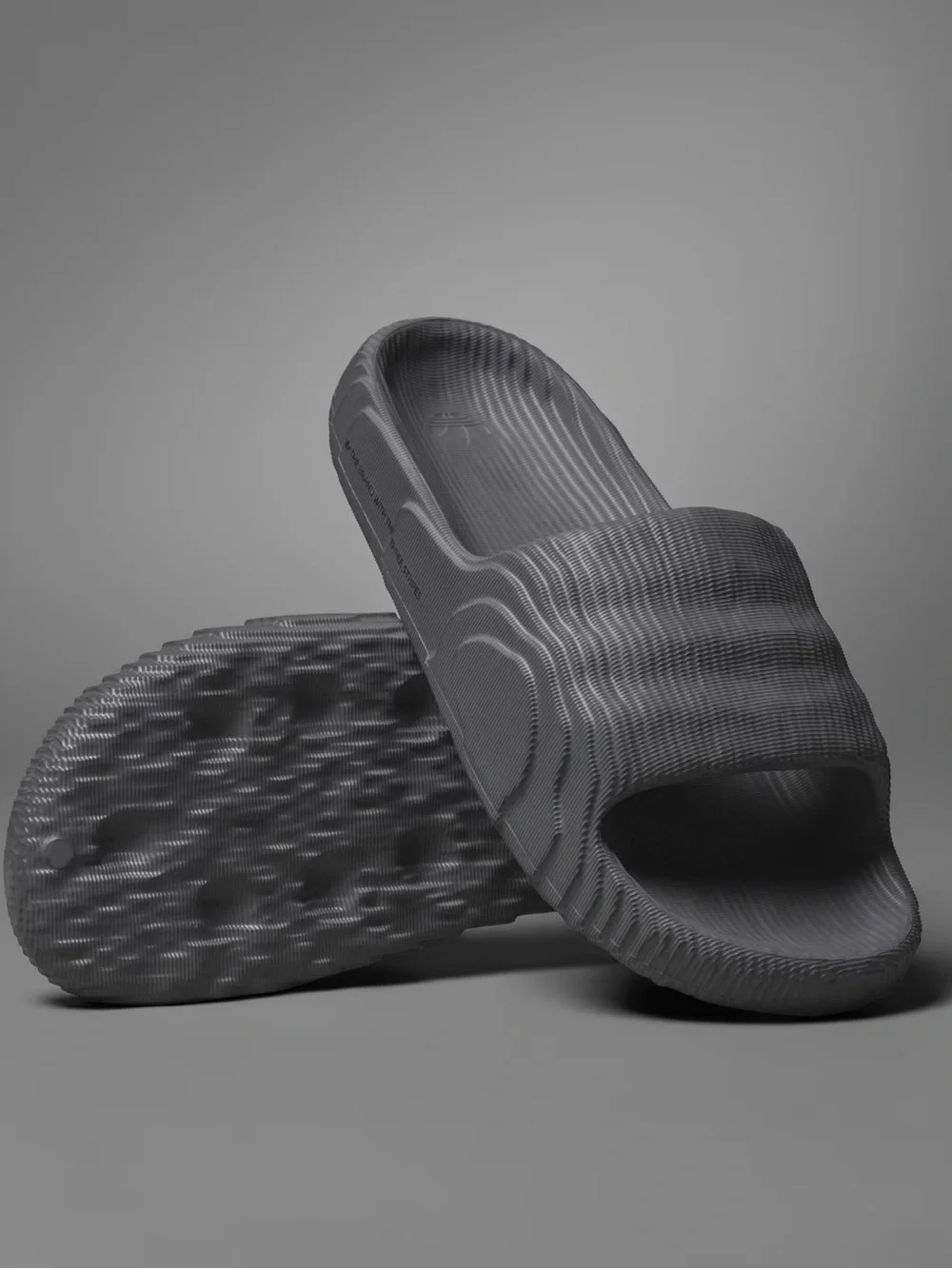 Adidas Adilette 22 Carbon Slides with a distinct 3D topographic texture